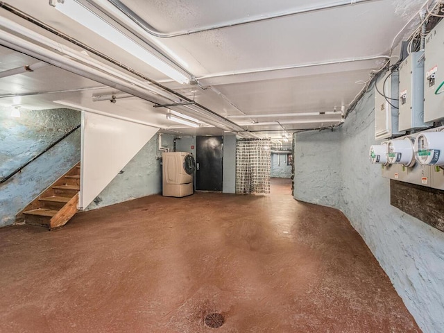 unfinished basement with washer / clothes dryer