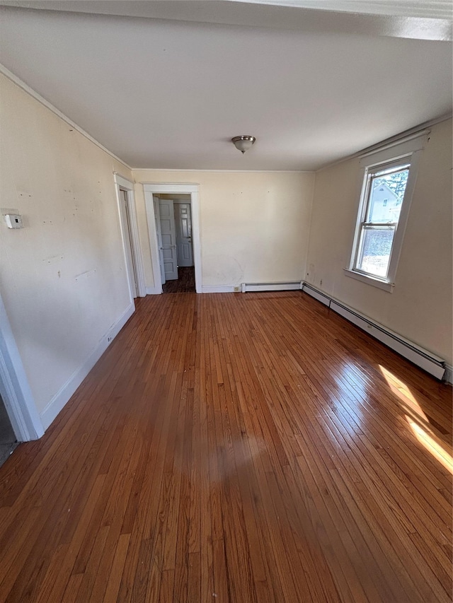 unfurnished room featuring a baseboard radiator, wood-type flooring, and baseboards