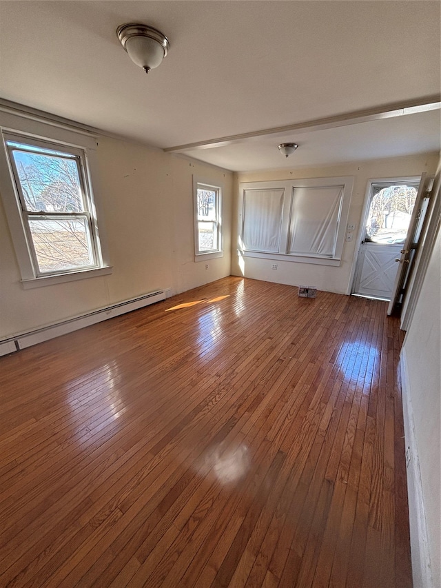 interior space featuring baseboard heating and dark wood finished floors