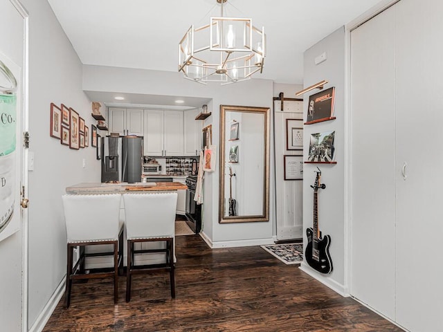 5800 Arlington Ave Unit 16A, Bronx, NY 10471 - kitchen with stainless steel fridge, dark wood-type flooring, a chandelier, hanging light fixtures, and a peninsula