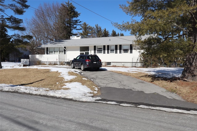 single story home with aphalt driveway