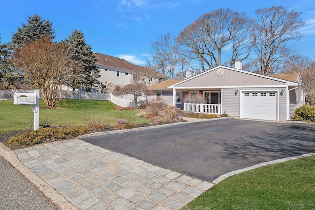 view of front of home with a front lawn, aphalt driveway, a porch, fence, and an attached garage