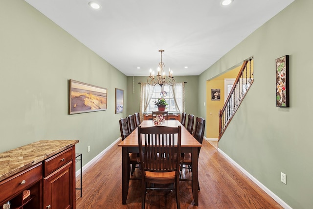 dining area with a notable chandelier, recessed lighting, dark wood-style flooring, baseboards, and stairway