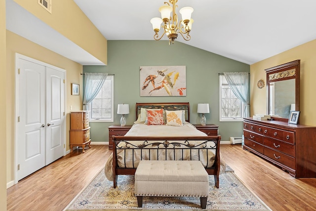 bedroom featuring lofted ceiling, light wood-style flooring, visible vents, and baseboard heating