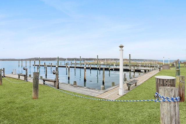 dock area with a yard and a water view