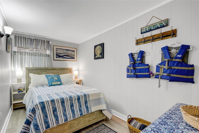 bedroom with baseboards and wood finished floors