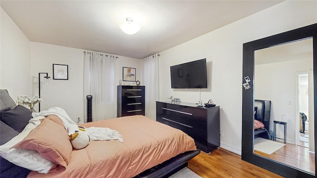 bedroom with baseboards and light wood-style floors