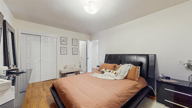 bedroom with light wood-style floors and a closet