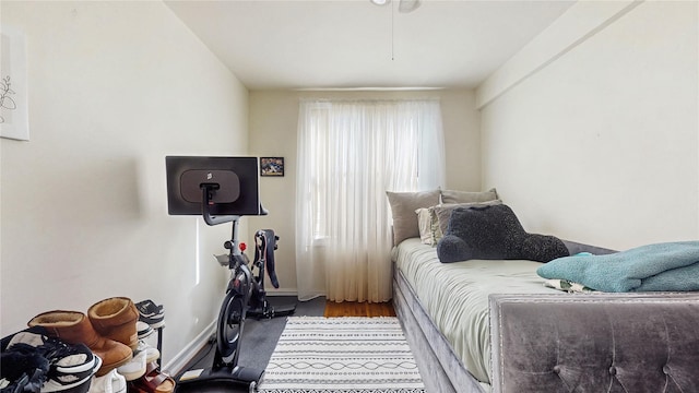 bedroom with wood finished floors and baseboards