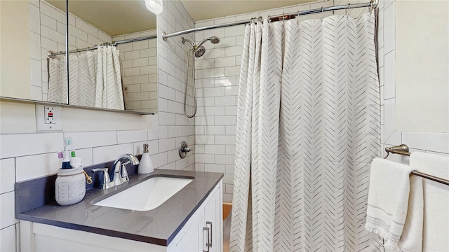 bathroom featuring curtained shower, decorative backsplash, tile walls, and vanity