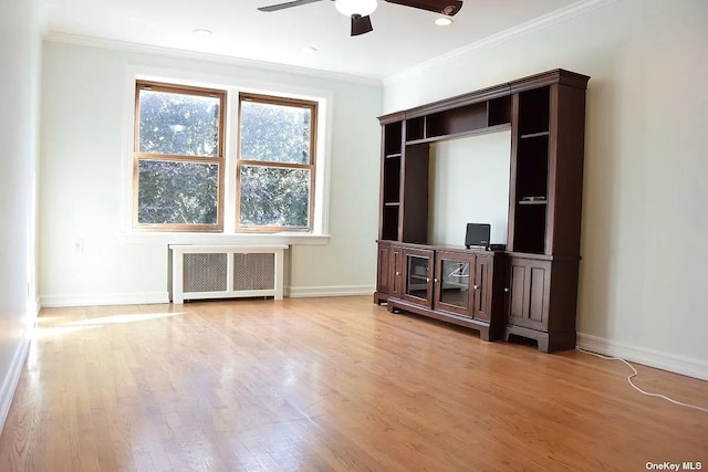 unfurnished living room with crown molding, radiator heating unit, baseboards, and light wood-style floors