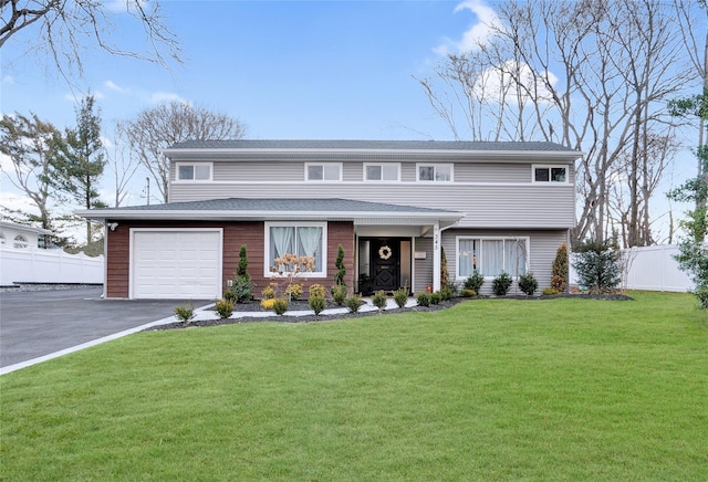 view of front facade featuring a garage, aphalt driveway, fence, and a front lawn