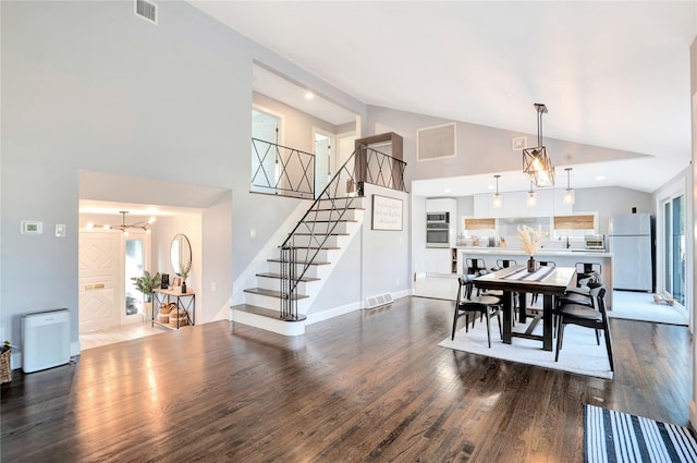 dining space with stairway, dark wood-style flooring, and visible vents