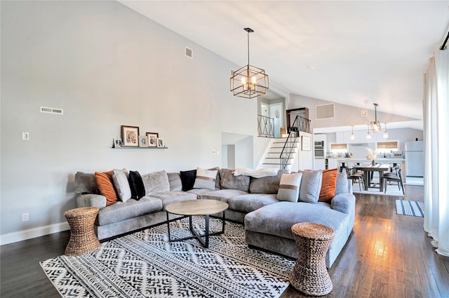 living room with dark wood finished floors, an inviting chandelier, high vaulted ceiling, baseboards, and stairs