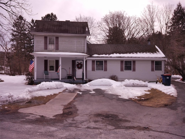 view of front of house featuring a porch and a shingled roof