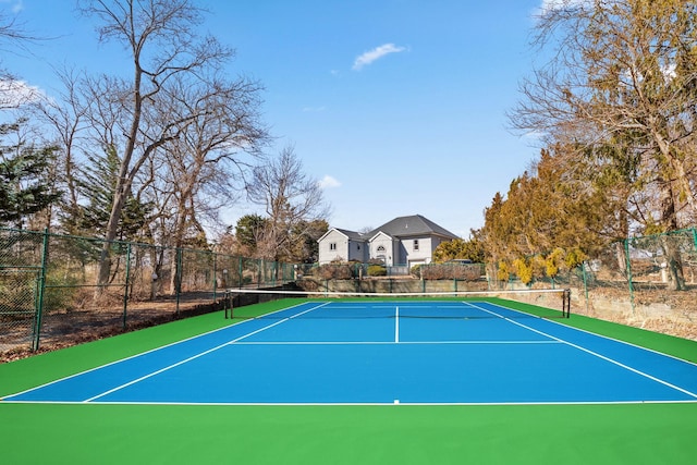 view of sport court featuring fence