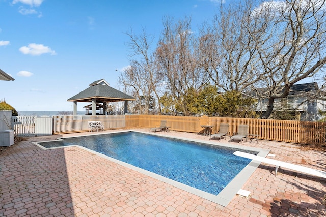 view of swimming pool featuring a patio, fence, a diving board, a gazebo, and a fenced in pool