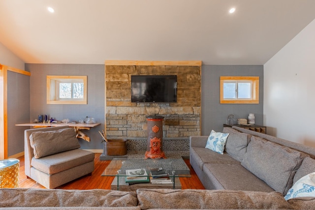 living area featuring recessed lighting, vaulted ceiling, and wood finished floors