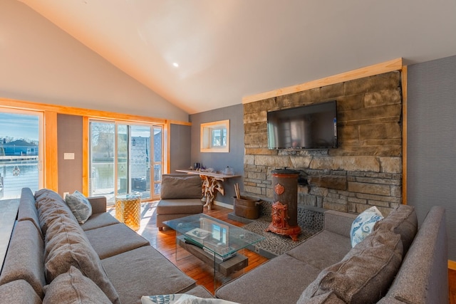 living area with high vaulted ceiling and wood finished floors