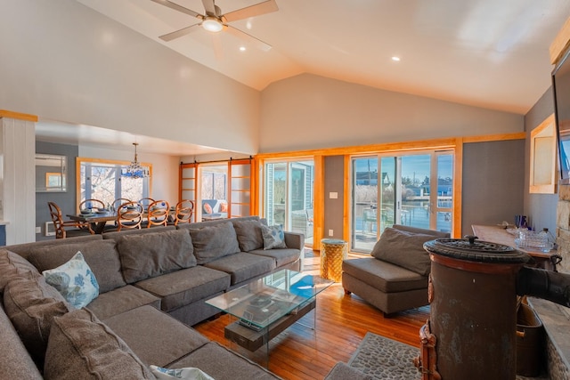 living area with a ceiling fan, high vaulted ceiling, wood finished floors, and recessed lighting