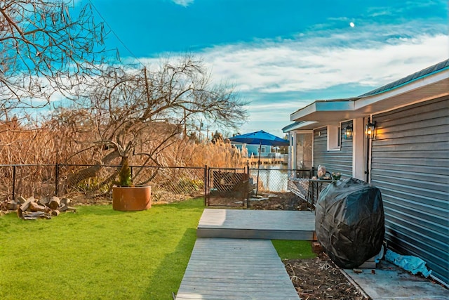 view of yard featuring fence and a wooden deck