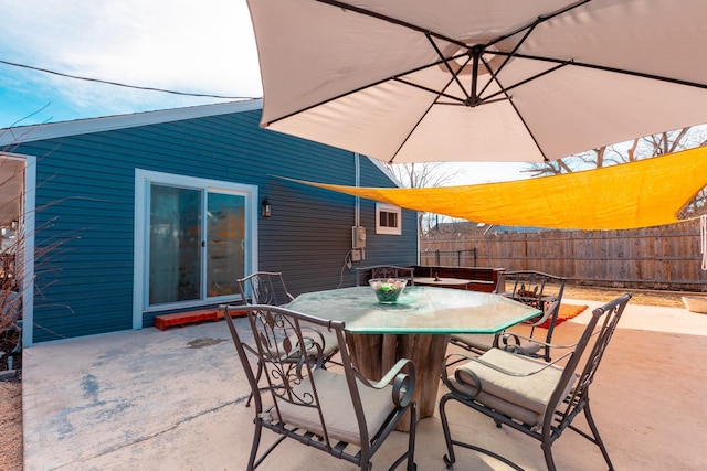 view of patio featuring fence and outdoor dining area