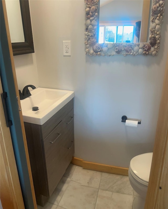 bathroom with tile patterned floors, vanity, toilet, and baseboards