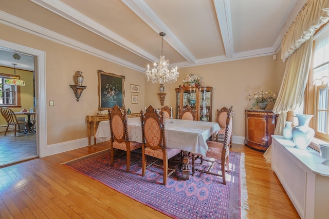 dining space featuring baseboards, ornamental molding, beamed ceiling, light wood-style floors, and a chandelier