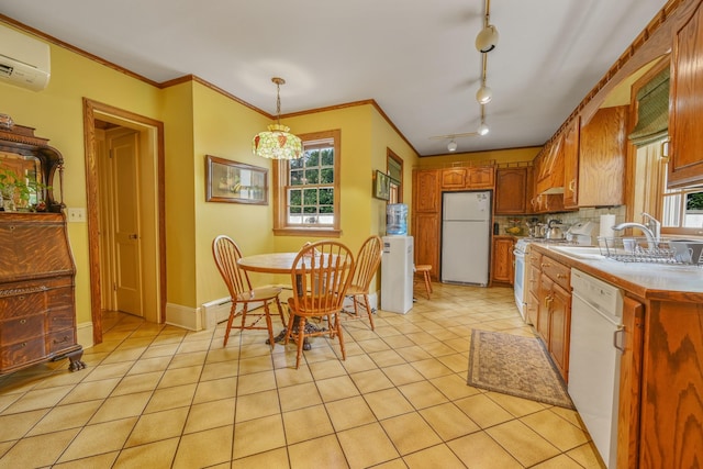 kitchen featuring white appliances, a wall mounted AC, light tile patterned flooring, and crown molding