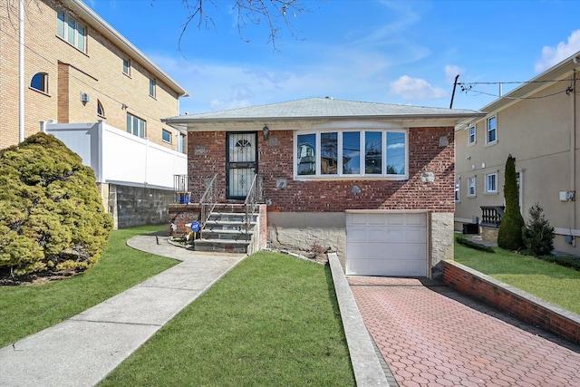 view of front facade with fence, an attached garage, a front lawn, decorative driveway, and brick siding