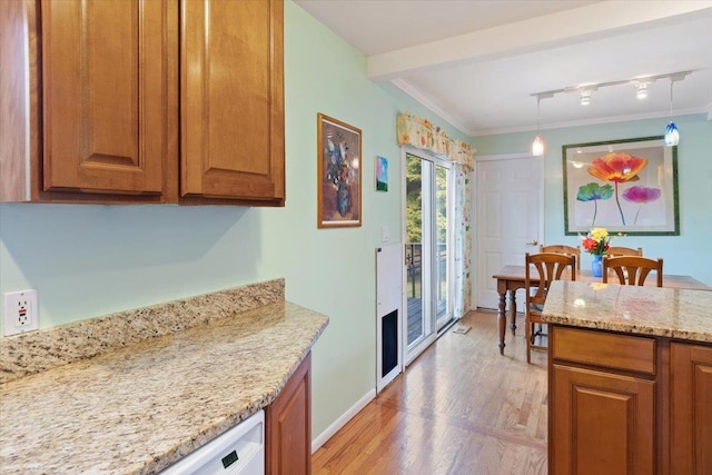 kitchen featuring pendant lighting, light wood-style floors, light stone counters, and brown cabinets