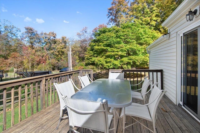 wooden deck featuring outdoor dining area