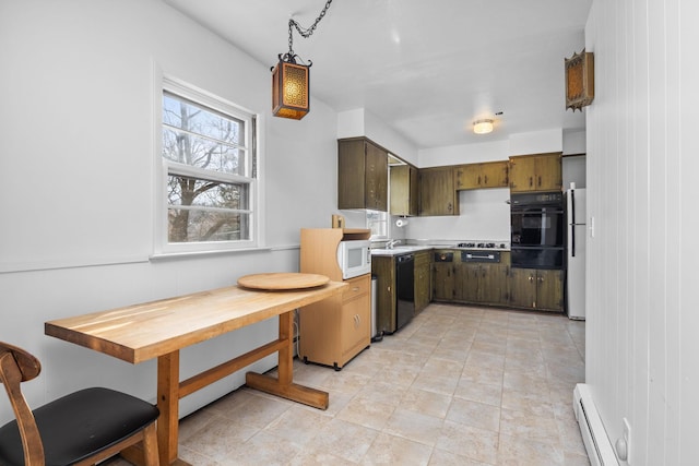 kitchen featuring a baseboard heating unit, light countertops, a warming drawer, and black appliances