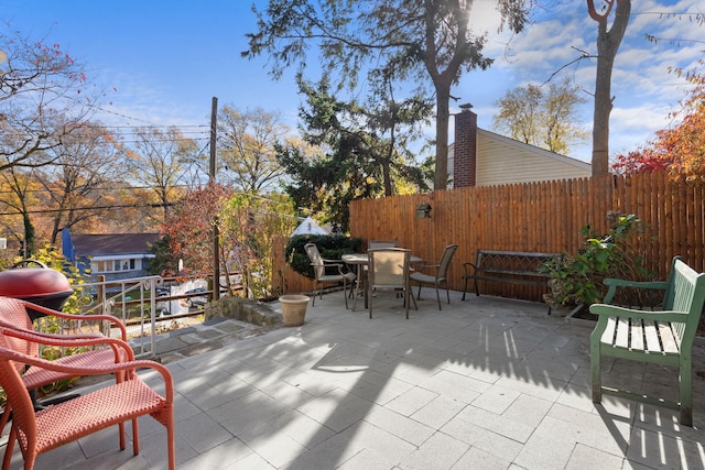 view of patio / terrace featuring outdoor dining area and fence