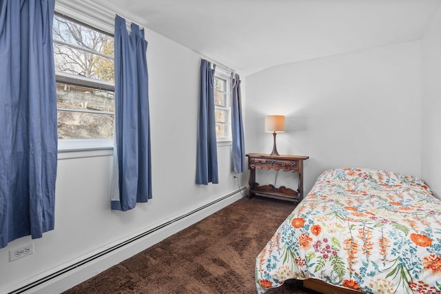 bedroom with lofted ceiling, a baseboard radiator, multiple windows, and dark colored carpet