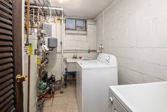 washroom featuring washing machine and dryer, laundry area, and a sink