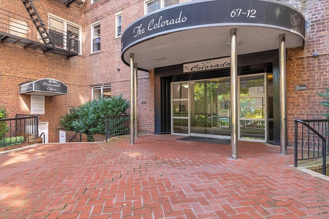 view of exterior entry with brick siding