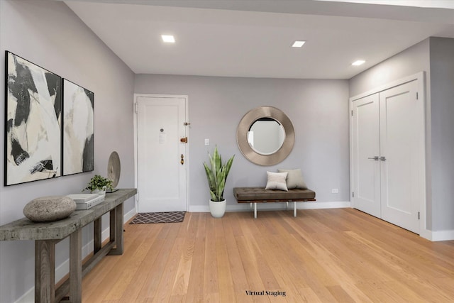 foyer entrance with baseboards, recessed lighting, and light wood-style floors