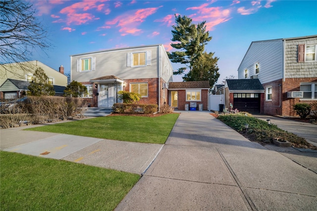 view of front facade featuring a garage, concrete driveway, brick siding, and a front lawn