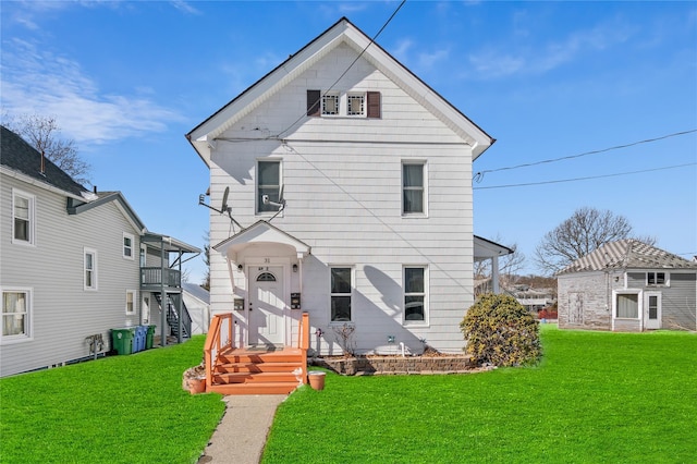 rear view of house with a yard