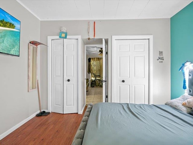 bedroom with wood finished floors and baseboards