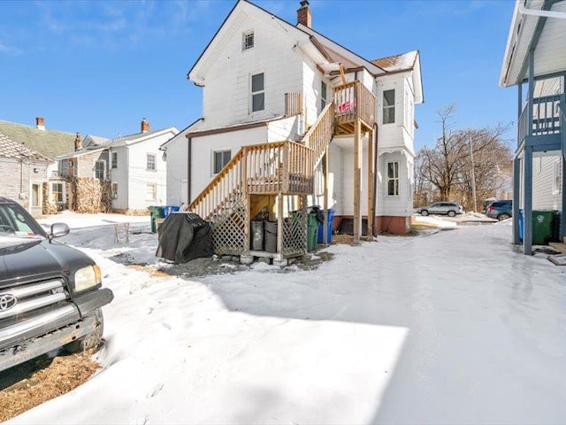 exterior space with stairway, a chimney, and a residential view