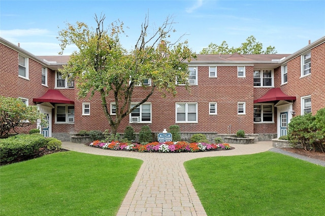 view of front of house with brick siding and a front lawn