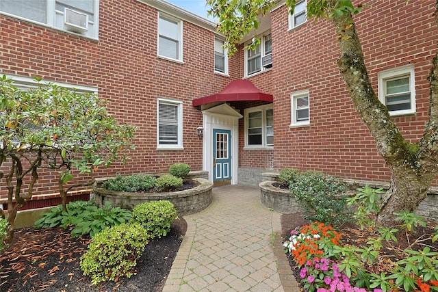 view of exterior entry with brick siding