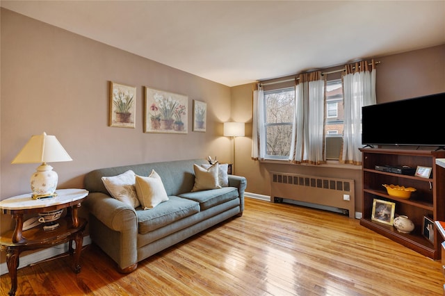 living area featuring radiator heating unit and wood finished floors