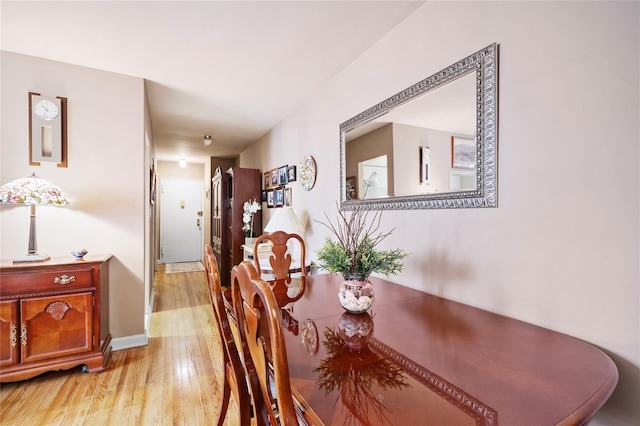 dining area featuring light wood-style flooring