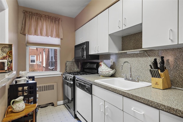 kitchen with light floors, radiator, white cabinetry, a sink, and black appliances