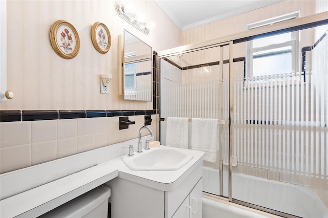 full bath with enclosed tub / shower combo, crown molding, tile walls, and vanity