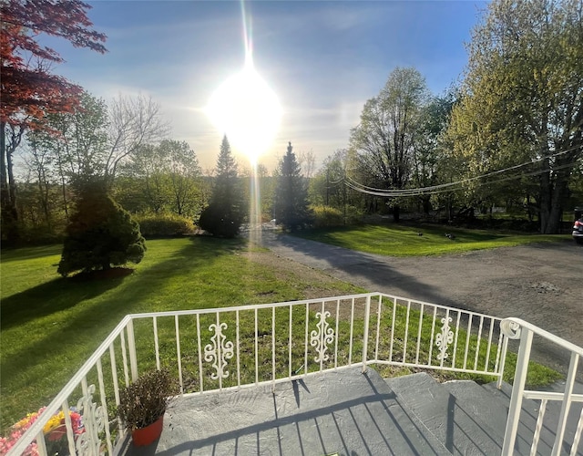 wooden deck featuring a lawn