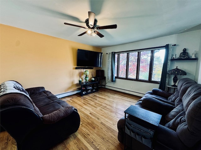 living area featuring baseboards, baseboard heating, a ceiling fan, and light wood-style flooring